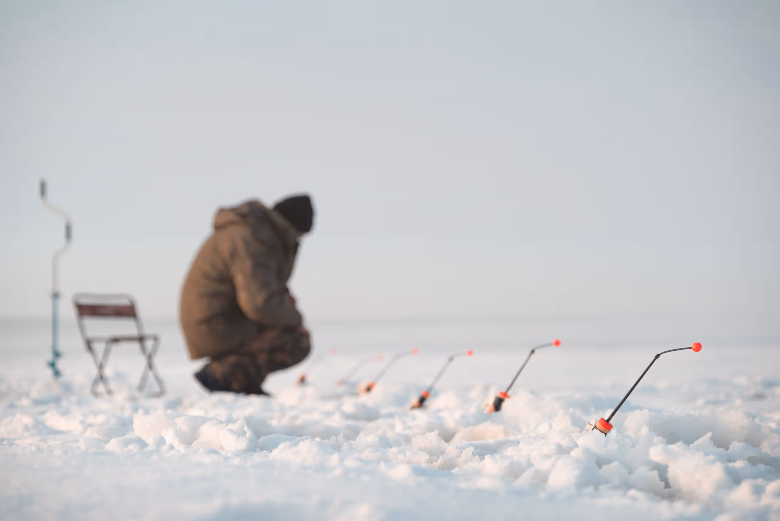 full length man fishing snow covered lake against sky scaled